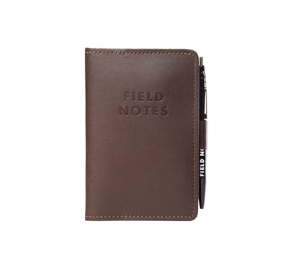 Daily Carry leather notebook cover with Field Notes stamped in black and with attached pen loop.