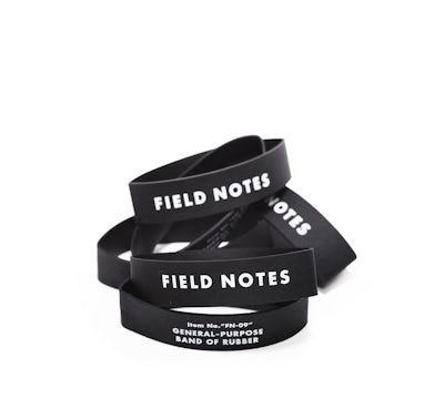 Pile of black rubber bands with white Field Notes logo on each.