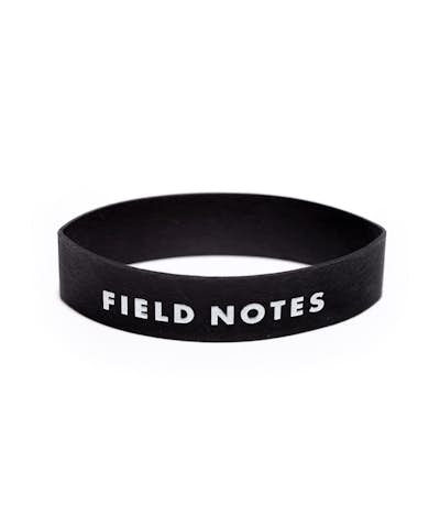 Close up of a single black rubber band with white Field Notes logo.