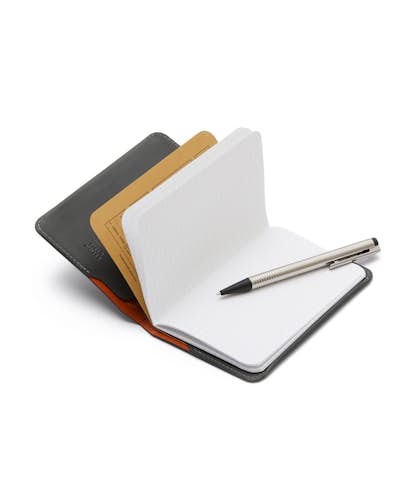 Everyday Inspiration leather notebook cover opened with a graph paper notebook and pen inside