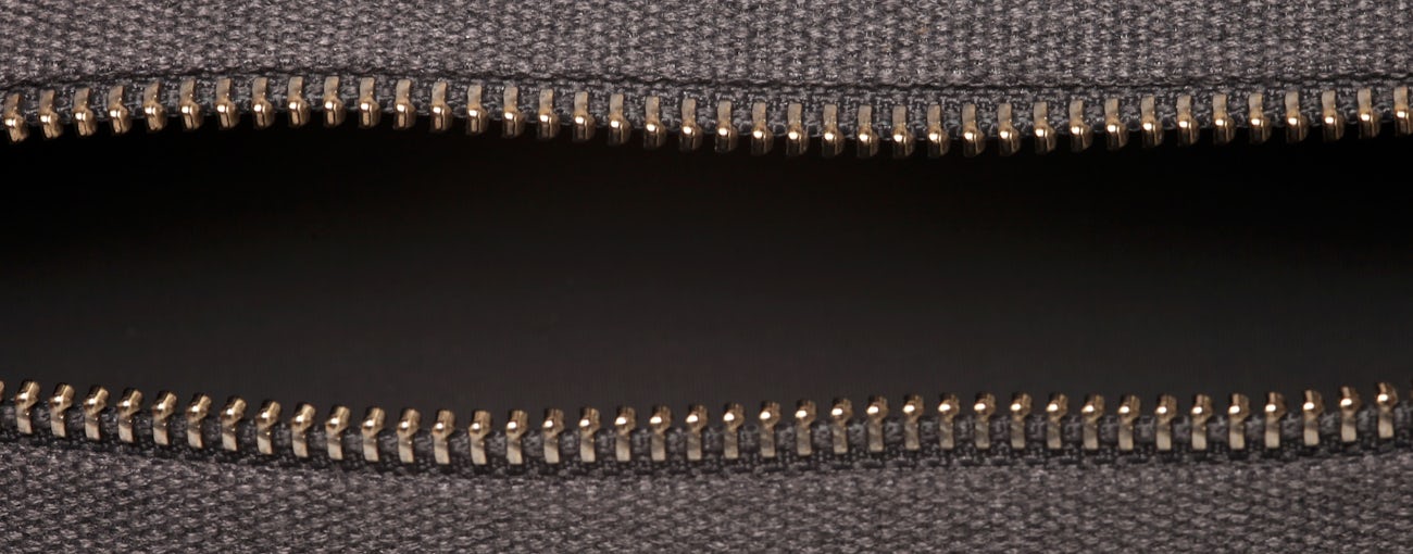 Zippered pencil case showing the detail of the zipper, unzipped.
