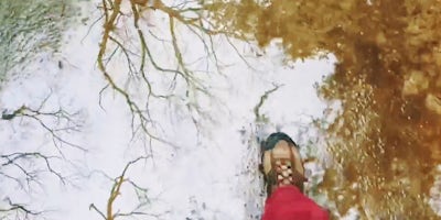 Photo of a foot standing in a puddle